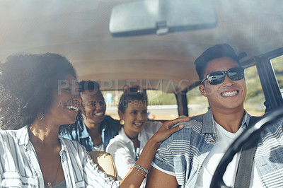 Buy stock photo Shot of a group of happy young friends going on a road trip together