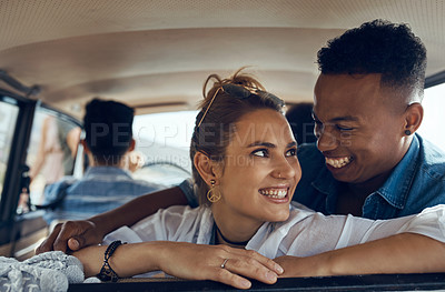 Buy stock photo Shot of a happy young couple going on a road trip with friends