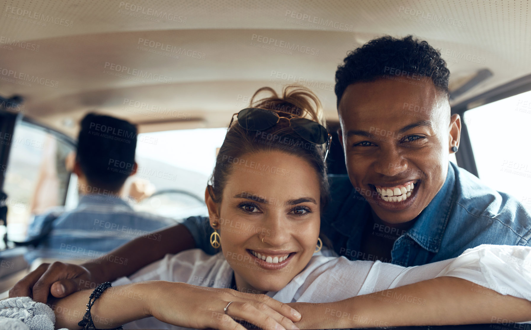 Buy stock photo Shot of a happy young couple going on a road trip with friends