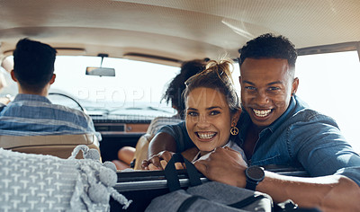 Buy stock photo Shot of a happy young couple going on a road trip with friends