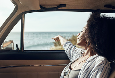 Buy stock photo Shot of a young woman enjoying a relaxing road trip