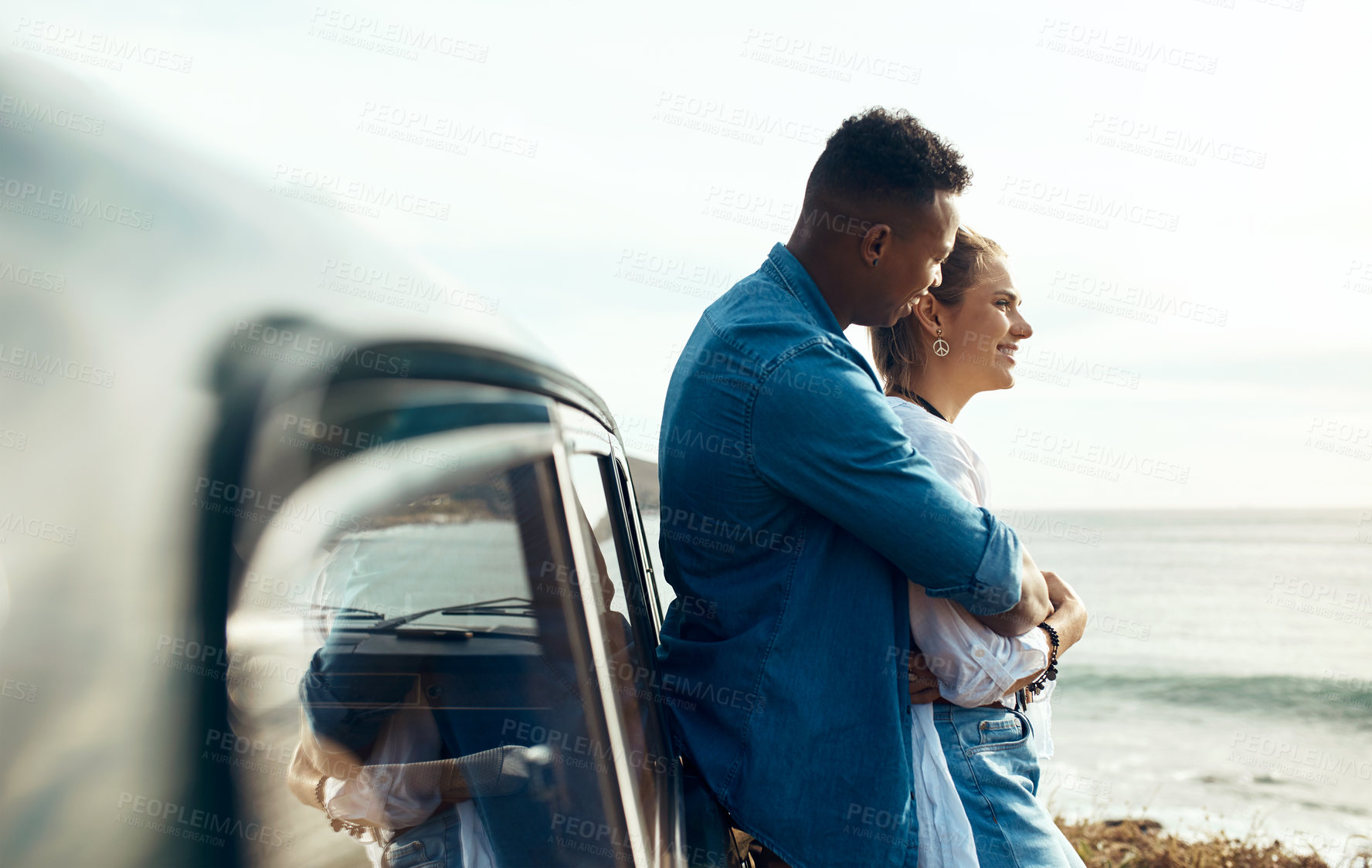 Buy stock photo Shot of a happy young couple looking at the view on a road trip along the coast