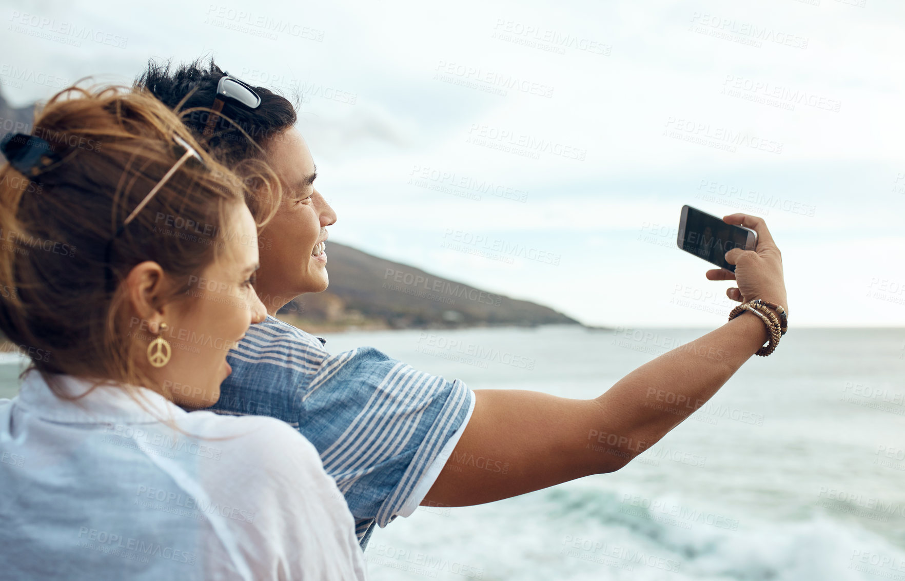 Buy stock photo Hug, selfie and happy with couple at beach for social media post, romantic getaway and bonding. Connection, love and photography with man and woman outdoor for honeymoon holiday, marriage and travel