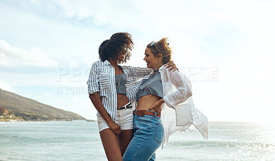 Buy stock photo Shot of two happy young friends enjoying a vacation along the coast