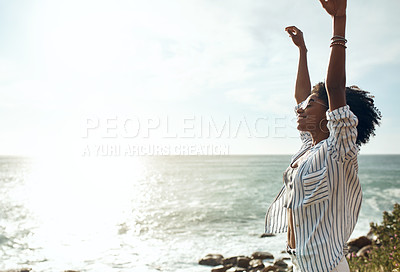Buy stock photo Shot of an attractive young woman enjoying a vacation along the coast