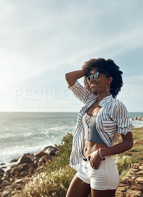 Buy stock photo Shot of an attractive young woman enjoying a vacation along the coast