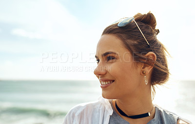 Buy stock photo Shot of an attractive young woman enjoying a vacation along the coast