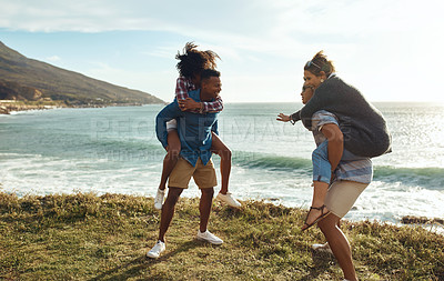 Buy stock photo Shot of a group of happy young friends having fun on a vacation along the coast
