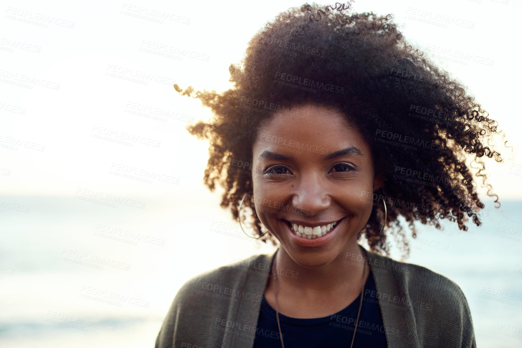 Buy stock photo Travel, portrait and black woman at beach with smile, fresh air and positive attitude on vacation. Wellness, space or person at sea with good mood, happy moment or unwind satisfaction on outdoor trip