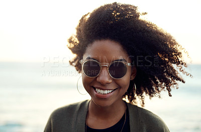 Buy stock photo Shot of an attractive young woman enjoying a vacation along the coast