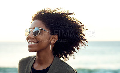 Buy stock photo Shot of an attractive young woman enjoying a vacation along the coast