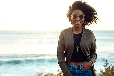 Buy stock photo Shot of an attractive young woman enjoying a vacation along the coast