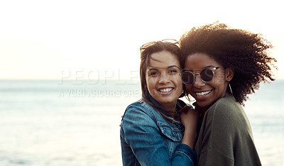 Buy stock photo Shot of two happy young friends enjoying a vacation along the coast