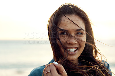 Buy stock photo Shot of an attractive young woman enjoying a vacation along the coast