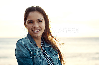 Buy stock photo Shot of an attractive young woman enjoying a vacation along the coast