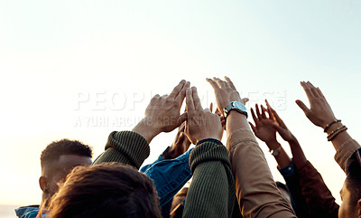 Buy stock photo Cropped shot of a group of friends raising their hands together in solidarity outdoors