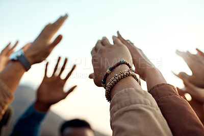 Buy stock photo Cropped shot of a group of friends raising their hands together in solidarity outdoors