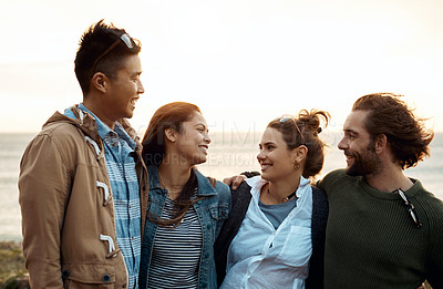 Buy stock photo Shot of a group of happy young friends enjoying a vacation along the coast
