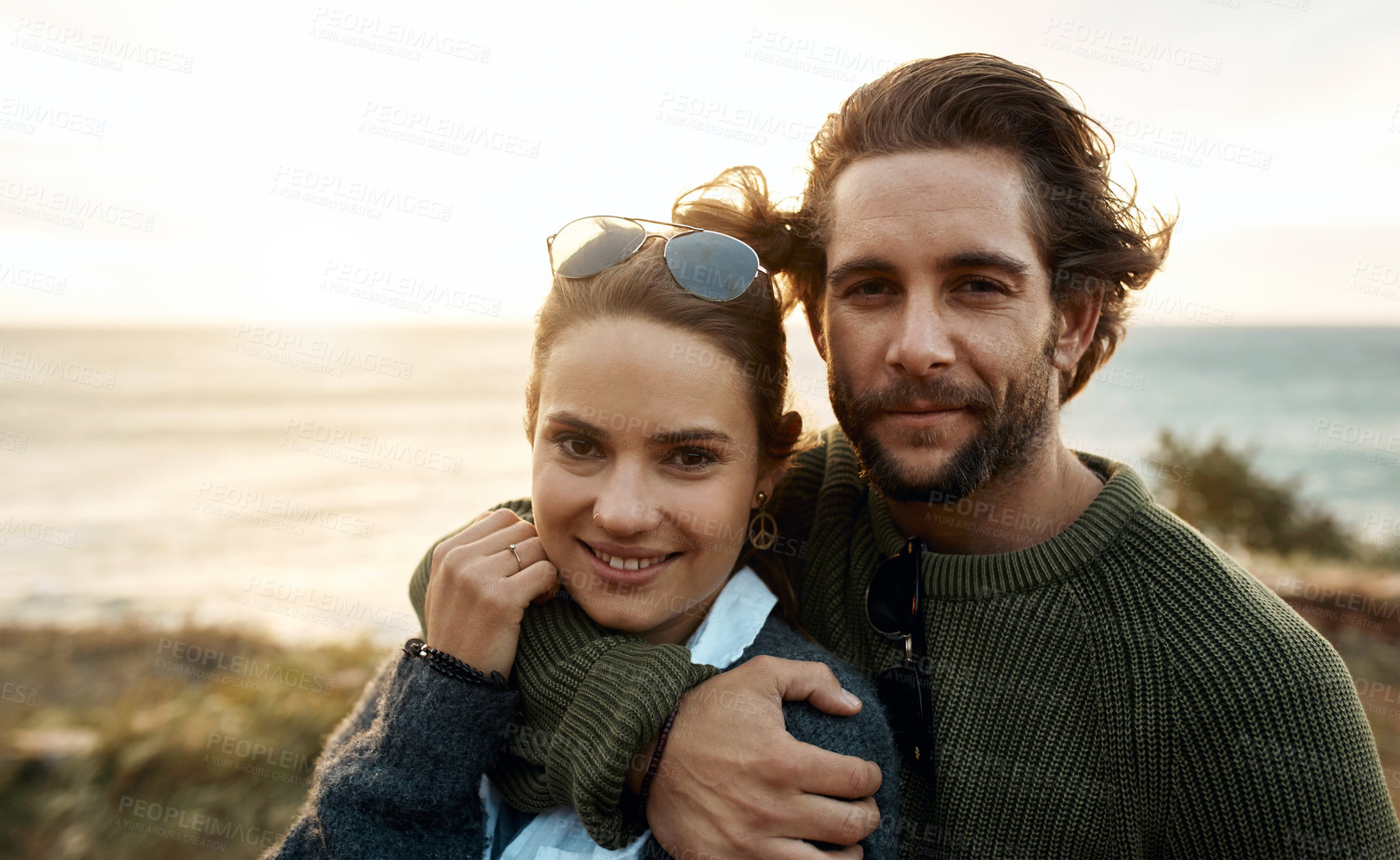 Buy stock photo hot of a happy young couple sharing a romantic moment on a vacation along the coast