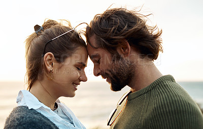 Buy stock photo hot of a happy young couple sharing a romantic moment on a vacation along the coast