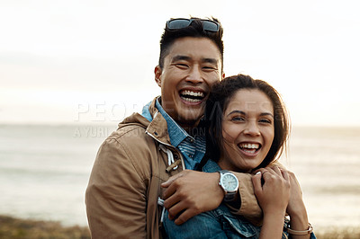 Buy stock photo hot of a happy young couple sharing a romantic moment on a vacation along the coast