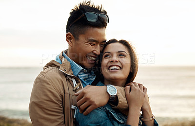 Buy stock photo hot of a happy young couple sharing a romantic moment on a vacation along the coast