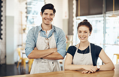 Buy stock photo Shot of two business owners in their coffee shop