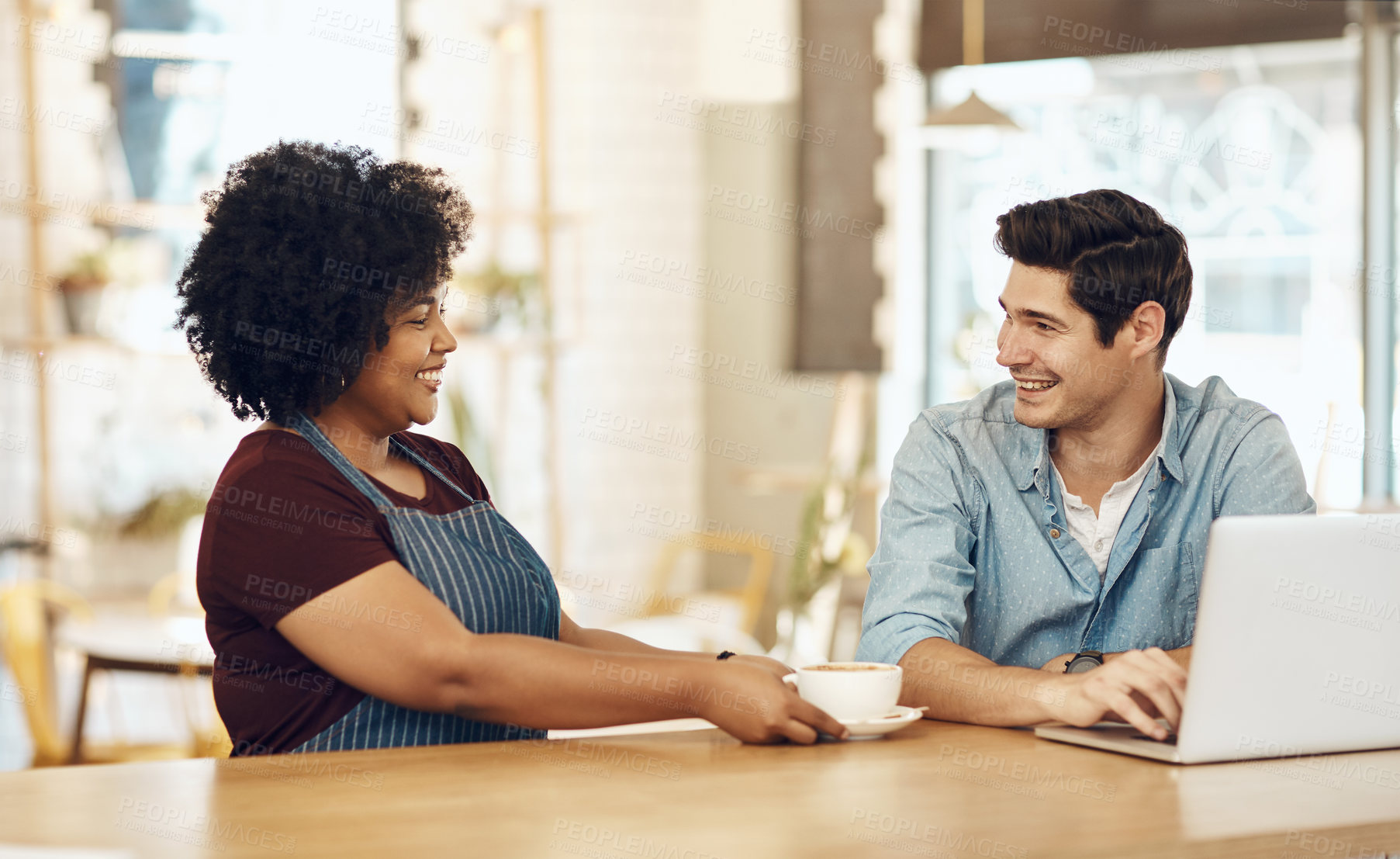 Buy stock photo Shot of a young woman serving a customer in a cafe