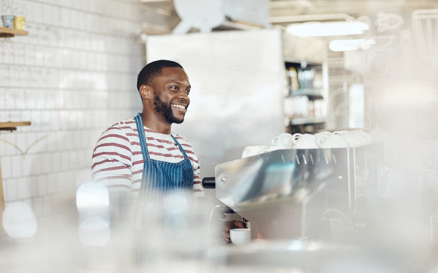 Buy stock photo Cropped shot of a handsome barista operating a coffee machine