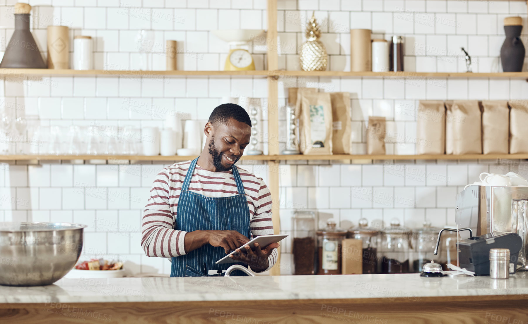 Buy stock photo Hospitality, review or barista in cafe with tablet, website check or delivery track on digital site. Happy, browse or black man in coffee shop with tech, online order or menu update on restaurant app