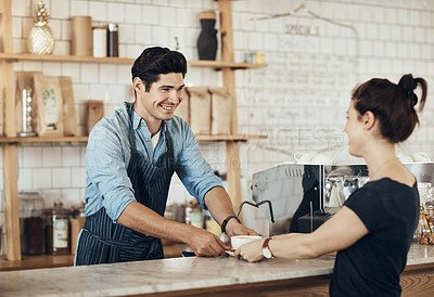 Buy stock photo Shot of a young man serving a customer in a cafe