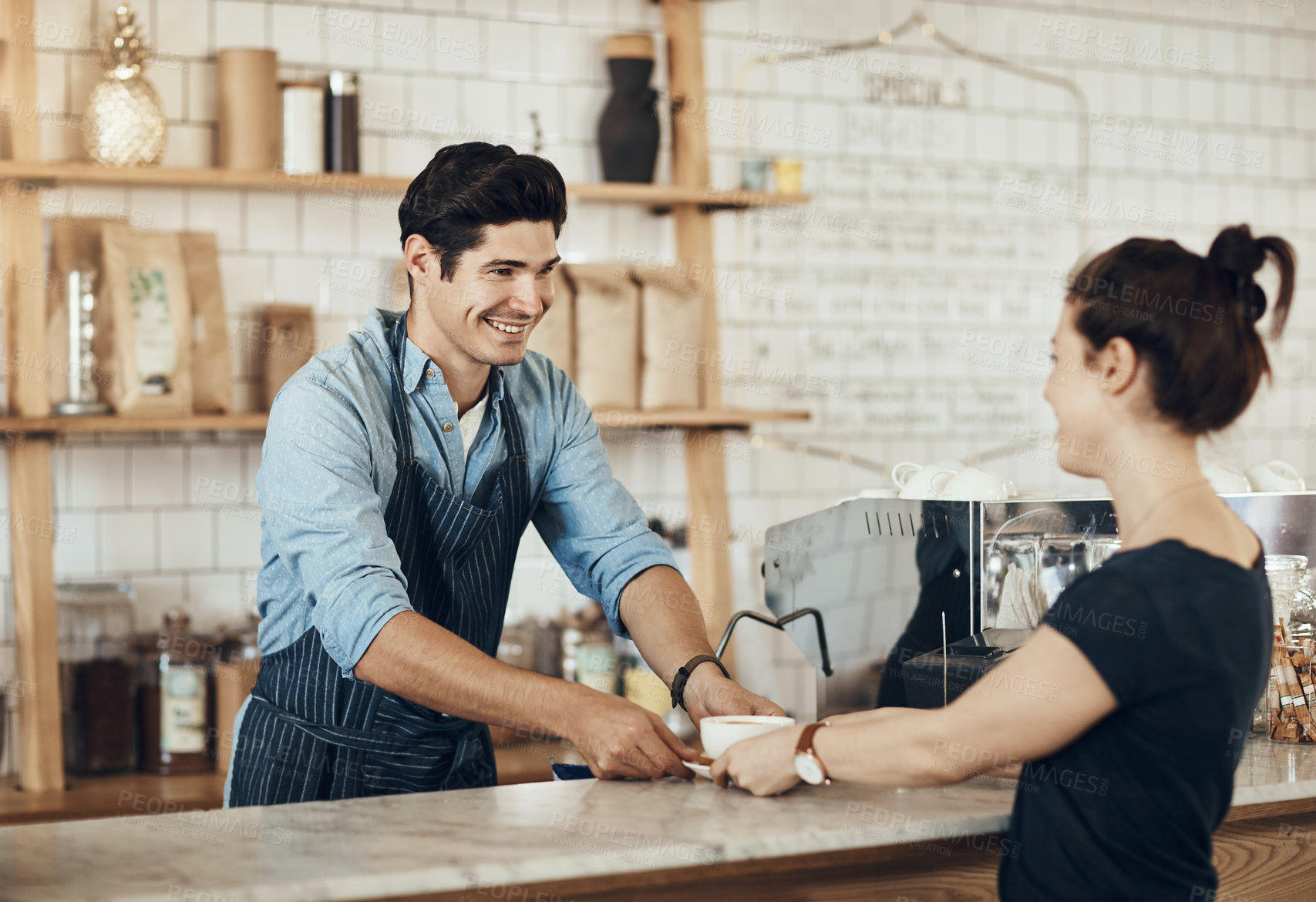 Buy stock photo Shot of a young man serving a customer in a cafe