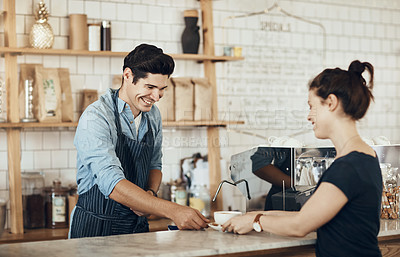 Buy stock photo Shot of a young man serving a customer in a cafe
