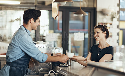 Buy stock photo Shot of a young man serving a customer in a cafe