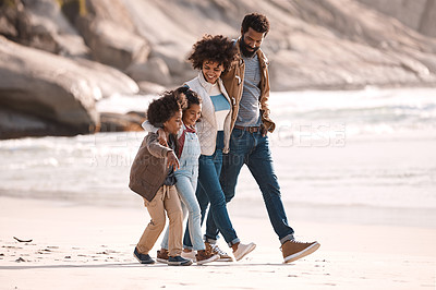 Buy stock photo Shot of an adorable little boy and girl going for a walk along the beach with their parents