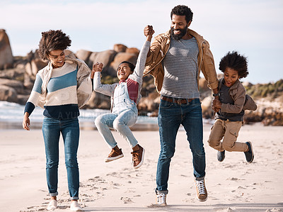 Buy stock photo Shot of an adorable little boy and girl going having fun at the beach with their parents