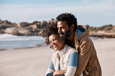 Buy stock photo Shot of a happy young couple spending a romantic day at the beach
