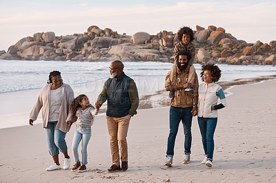 Buy stock photo Shot of an adorable little boy and girl having a fun day at the beach with their parents and grandparents