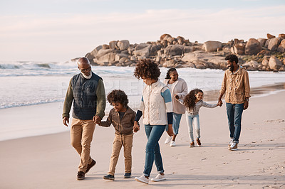 Buy stock photo Shot of an adorable little boy and girl having a fun day at the beach with their parents and grandparents