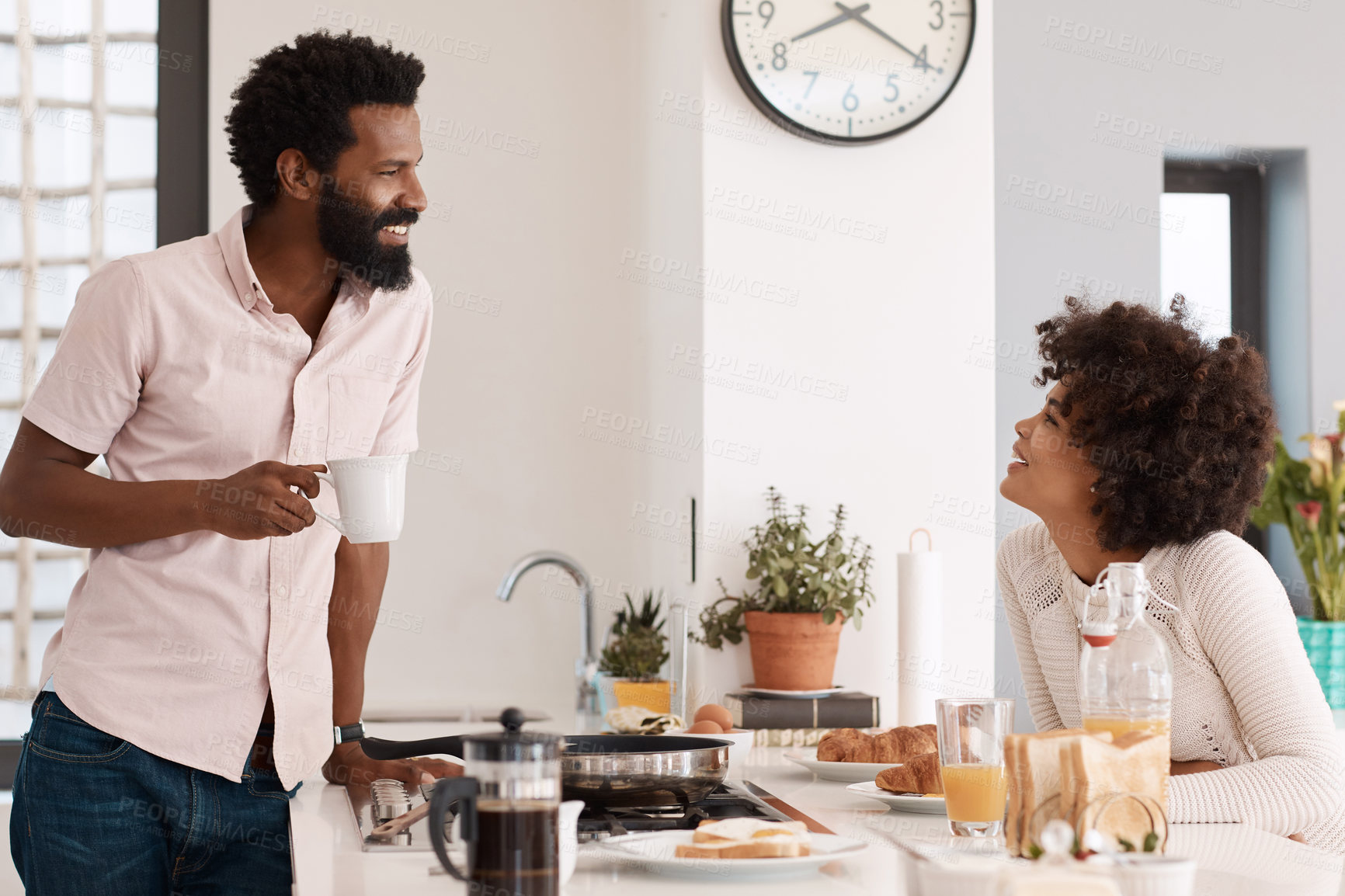 Buy stock photo Cropped shot of a couple having breakfast in their kitchen