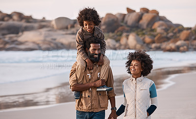 Buy stock photo Shot of a happy young family going for a walk along the beach