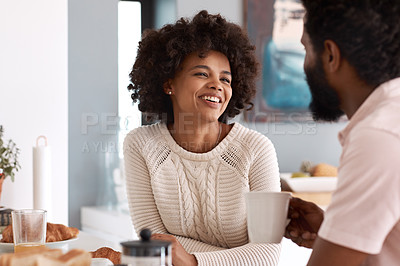 Buy stock photo Cropped shot of a couple having breakfast in their kitchen