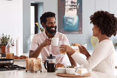 Buy stock photo Cropped shot of a couple having breakfast in their kitchen