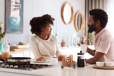 Buy stock photo Cropped shot of a couple having breakfast in their kitchen
