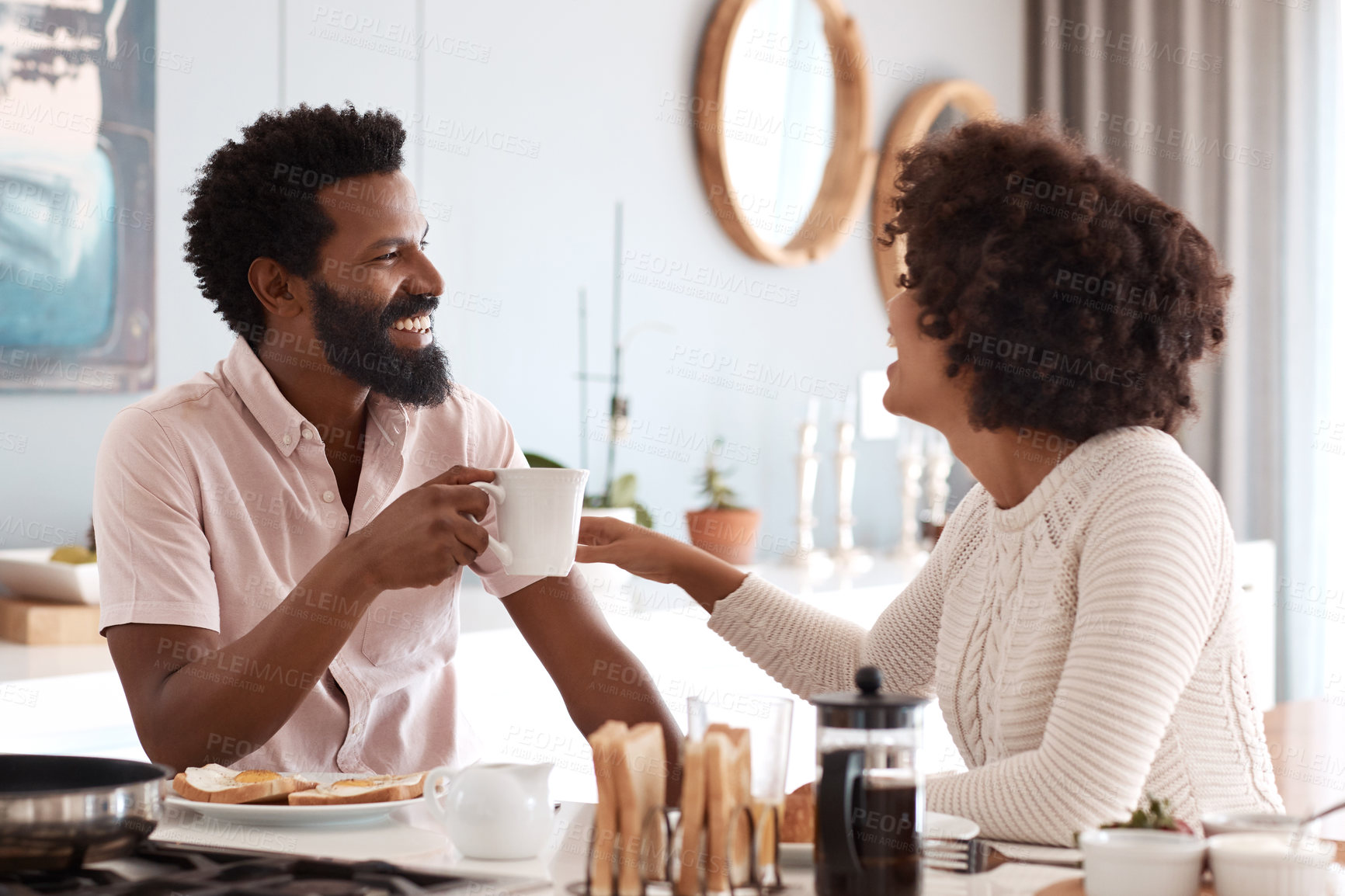 Buy stock photo Couple, laugh and breakfast at kitchen with coffee, funny conversation or joke for bonding together. Happy, African people and dating in home with beverage, quality time and morning meal with humor.