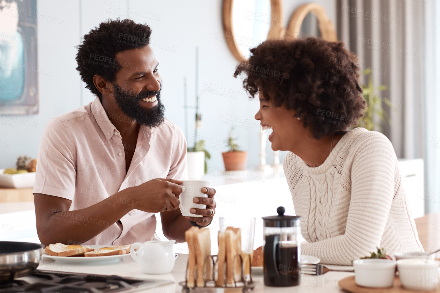 Buy stock photo Cropped shot of a couple having breakfast in their kitchen