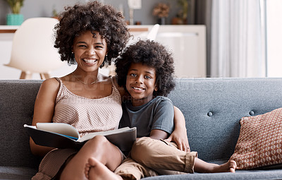 Buy stock photo Portrait of an adorable little boy reading a book and spending time with his mother at home