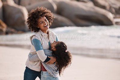 Buy stock photo Shot of an adorable little girl having a fun day at the beach with her mother