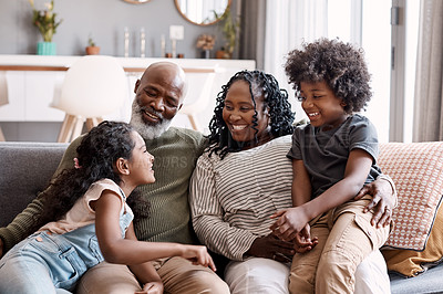 Buy stock photo Shot of two adorable young siblings bonding and spending time with their grandparents at home