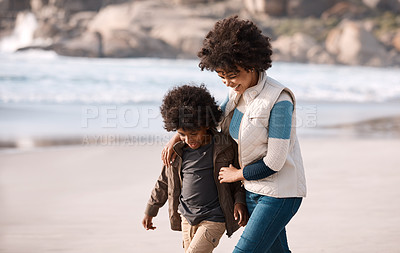 Buy stock photo Shot of an adorable little boy having a fun day at the beach with his mother
